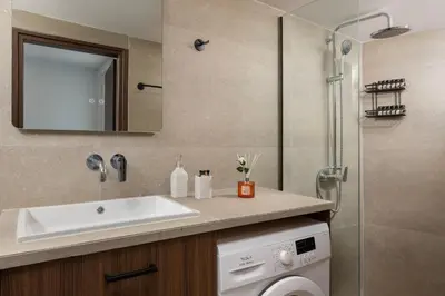 a bathroom with a sink and a shower at Icarus Residence in Rhodes Town
