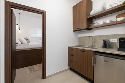 a kitchen with a door leading to a bedroom at Icarus Residence in Rhodes Town