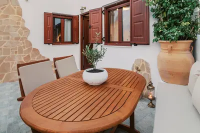 a wooden dining room table with a vase on it at Lindos Zen luxury villa in Líndos