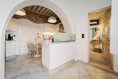 a kitchen with white walls and an archway at Lindos Zen luxury villa in Líndos