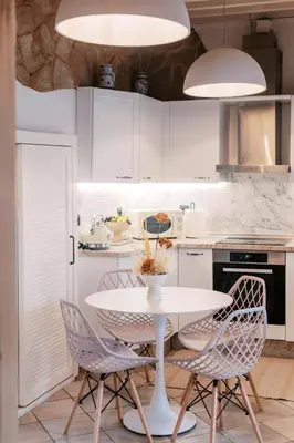 a white kitchen with a white table and chairs at Lindos Zen luxury villa in Líndos
