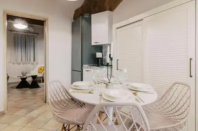 a white dining room with a white table and chairs at Lindos Zen luxury villa in Líndos