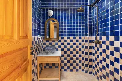 a blue tiled bathroom with a sink and a mirror at Villa Vasoula Lindos, Jasmine and Gardenia Suite in Líndos