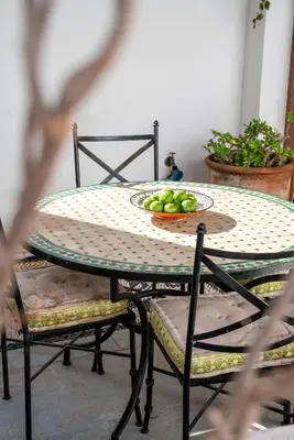 a table and chairs with a plate of fruit on it at Villa Vasoula Lindos, Jasmine and Gardenia Suite in Líndos
