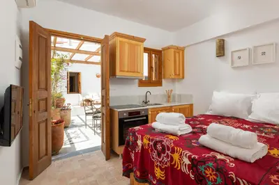 a bedroom with a bed with towels on it at Villa Vasoula Lindos, Jasmine and Gardenia Suite in Líndos