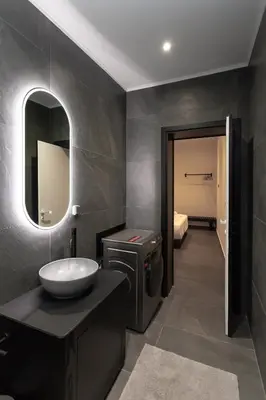 a bathroom with a sink and a mirror at HUGme Suite in Kalithies