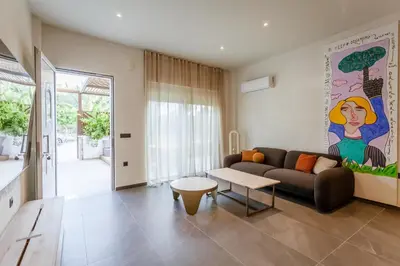 a living room with a couch and a table at HUGme Suite in Kalithies