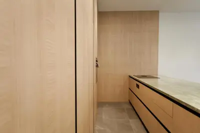 a kitchen with wooden cabinets and a counter top at HUGme Suite in Kalithies