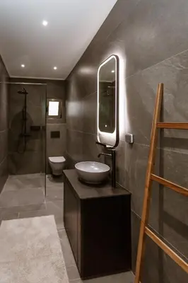 a bathroom with a sink and a mirror at HUGme Suite in Kalithies