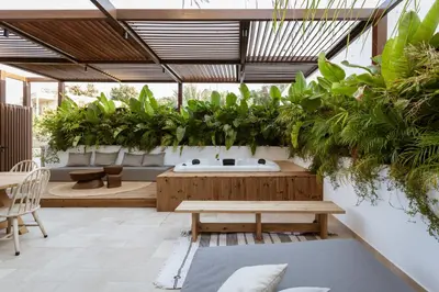 a patio with a bunch of plants and a bench at HUGme Suite in Kalithies
