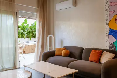 a living room with a couch and a table at HUGme Suite in Kalithies
