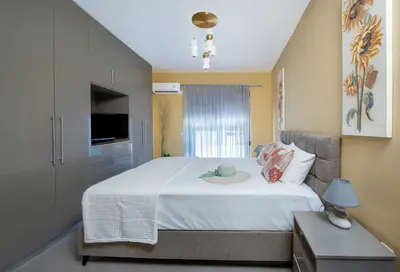 a bedroom with a bed with a hat on it at Magical House in Ialyssos