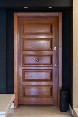 a wooden door in a room with a black wall at House of Paralympic Athlete Mike Seitis in Rhodes Town