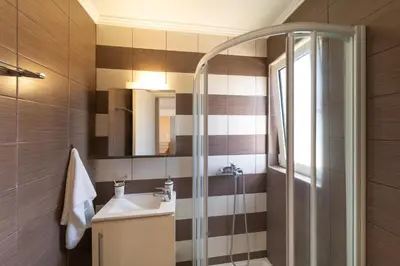 a bathroom with a sink and a shower at Fiore D'oriente Apartments in Rhodes Town