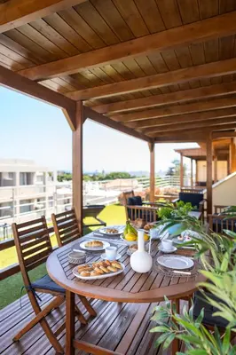 a wooden table with food on it on a patio at Fiore D'oriente Apartments in Rhodes Town