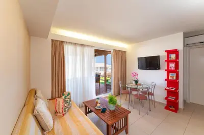 a living room with a couch and a table at Fiore D'oriente Apartments in Rhodes Town