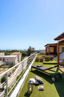 a balcony with grass and a table and a bench at Fiore D'oriente Apartments in Rhodes Town