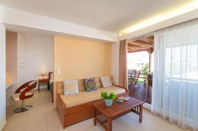 a living room with a couch and a table at Fiore D'oriente Apartments in Rhodes Town