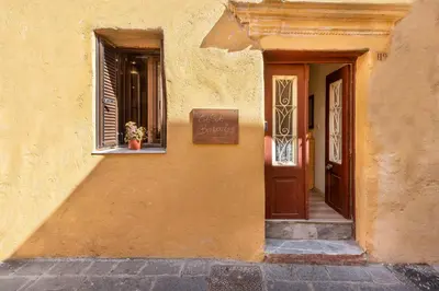 a building with a window with a potted plant on a window sill at Casa Baboulas Old Town in Rhodes Town