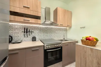a kitchen with a stove and a basket of fruit at Casa Baboulas Old Town in Rhodes Town