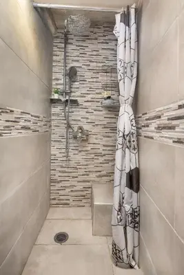 a bathroom with a shower with a shower curtain at Casa Baboulas Old Town in Rhodes Town