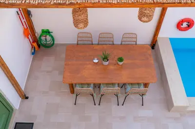 an overhead view of a wooden table and chairs at Villa Emerald in Koskinou
