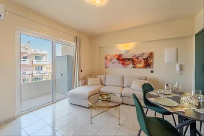 a living room with a couch and a table at Irem's sunrise suite! in Rhodes Town