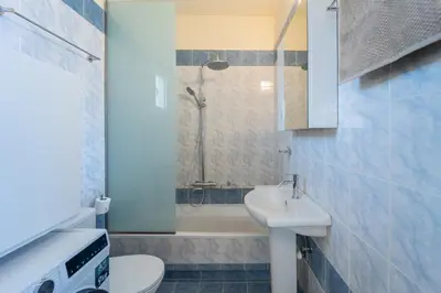 a bathroom with a sink and a toilet and a tub at Irem's sunrise suite! in Rhodes Town