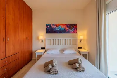 a bedroom with a bed with two pillows at Irem's sunrise suite! in Rhodes Town
