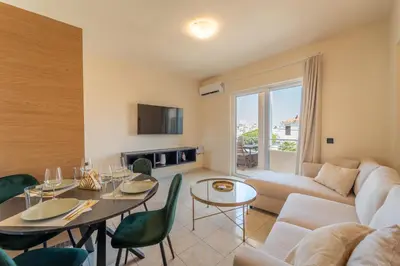 a living room with a couch and a table at Irem's sunrise suite! in Rhodes Town