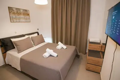 a hotel room with a bed with towels on it at Sinani Villa - Garden Oasis with Private Pool in Kolimbia