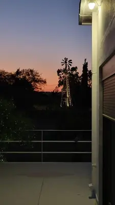 a view of a palm tree in the distance from a building at Aegean Villa & Garden in Faliraki in Faliraki