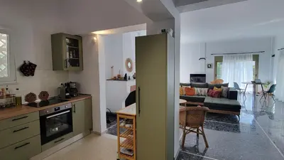 a kitchen and a living room with a couch at Aegean Villa & Garden in Faliraki in Faliraki