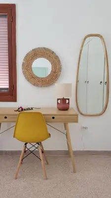 a desk with a yellow chair and a mirror at Aegean Villa & Garden in Faliraki in Faliraki