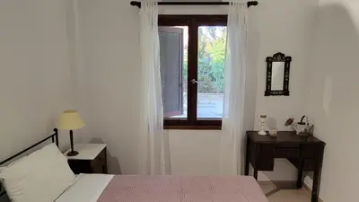a bedroom with a bed and a window at Aegean Villa & Garden in Faliraki in Faliraki