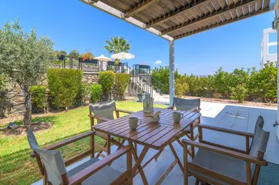 a wooden table and chairs on a patio at Villa Mariani in Kalathos