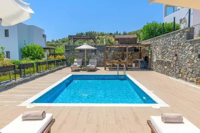a swimming pool in the middle of a house at Villa Mariani in Kalathos