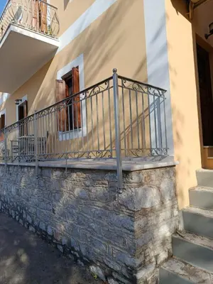 a railing on the side of a building with stairs at Doukissa's Apartment in Symi