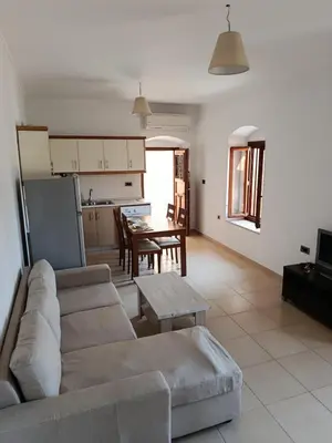 a living room with a couch and a table at Doukissa's Apartment in Symi
