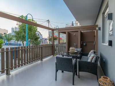 a balcony with a table and chairs on a balcony at My Savvas Studios in Haraki