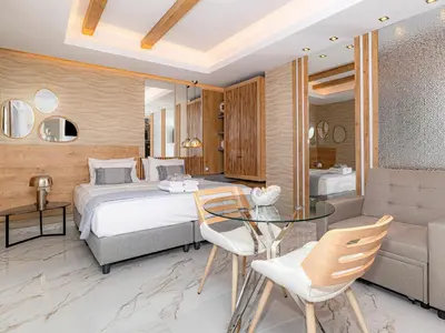 a bedroom with a bed and a glass table at My Savvas Studios in Haraki