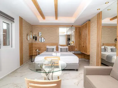a bedroom with two beds and a glass table at My Savvas Studios in Haraki