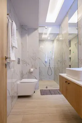 a bathroom with a tub and a toilet and a sink at My Savvas Studios in Haraki