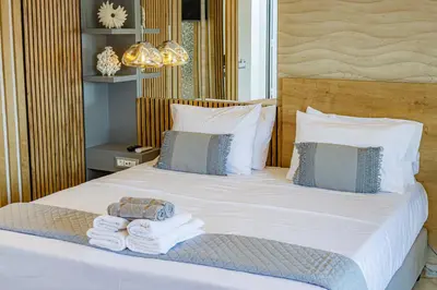 a bedroom with a bed with towels on it at My Savvas Studios in Haraki