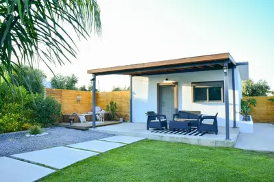 a small house with a patio at Eléa Blu Pool & Garden in Afantou