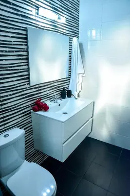 a bathroom with a white sink and a toilet at Eléa Blu Pool & Garden in Afantou