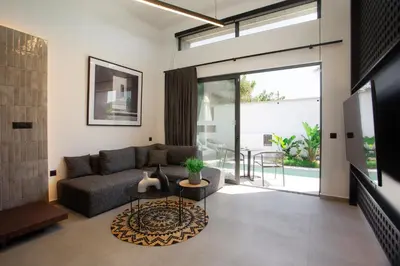 a living room with a couch and a table at Three Doors Villa Complex in Faliraki
