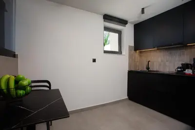 a kitchen with a table with green apples on it at Three Doors Villa Complex in Faliraki