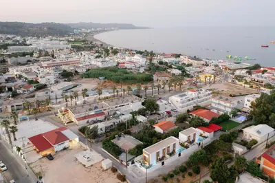 an aerial view of a town next to the water at Three Doors Villa Complex in Faliraki