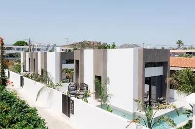 an external view of a building with a swimming pool at Three Doors Villa Complex in Faliraki